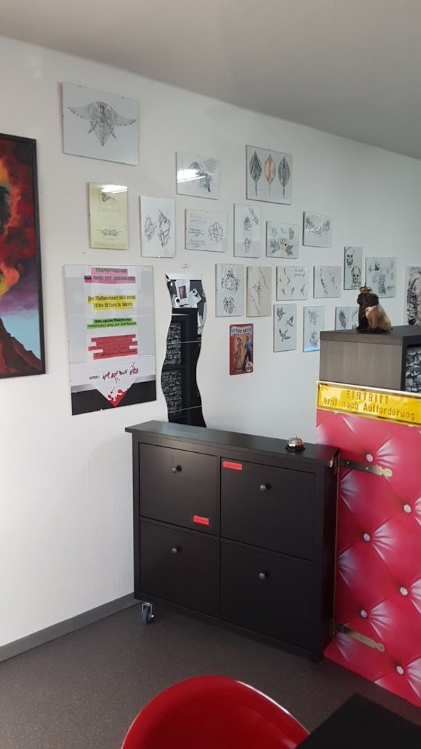 a room with a red chair and a black cabinet