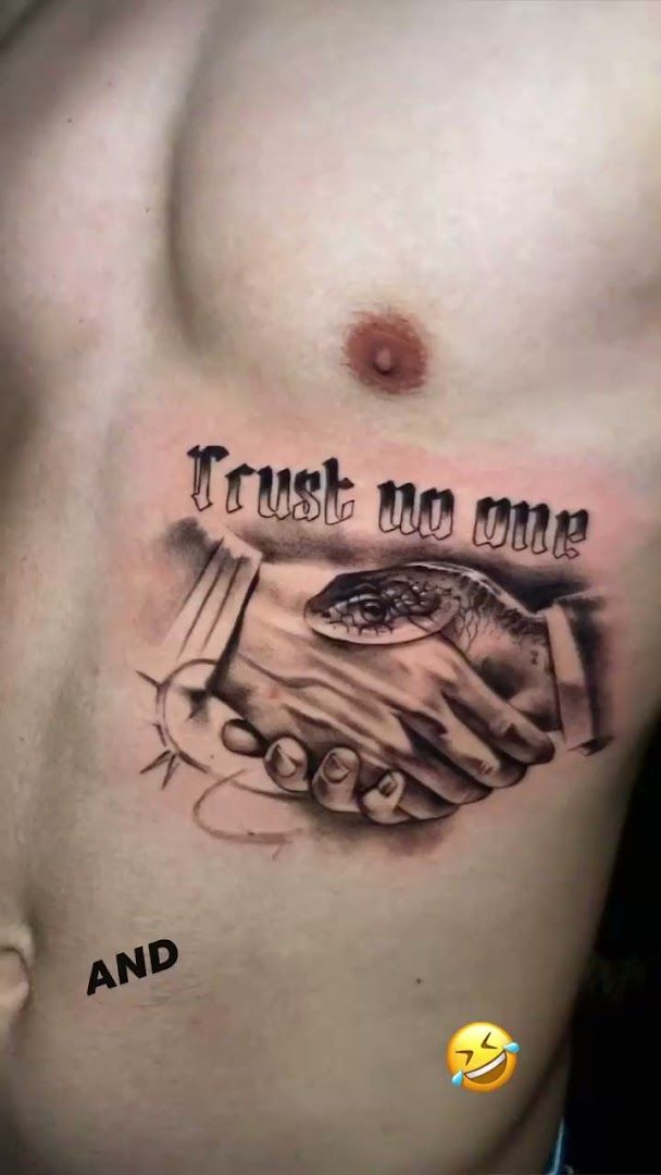 a cover-up tattoo with the words trust me and a hand holding a fish, nürnberg, germany