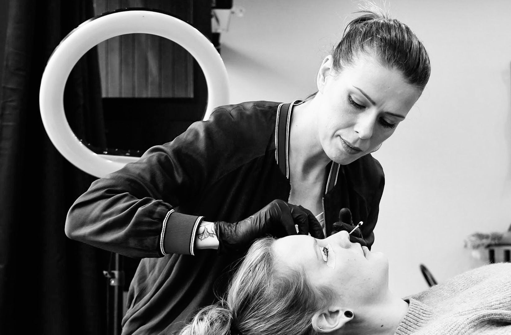 a woman getting her hair done by a hairdre