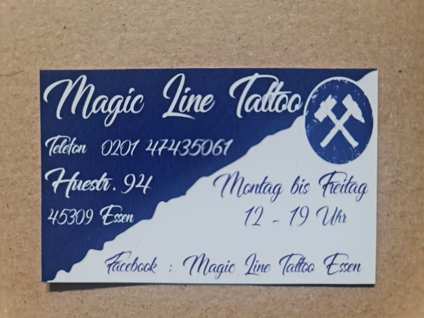 a blue and white business card with a cross on it