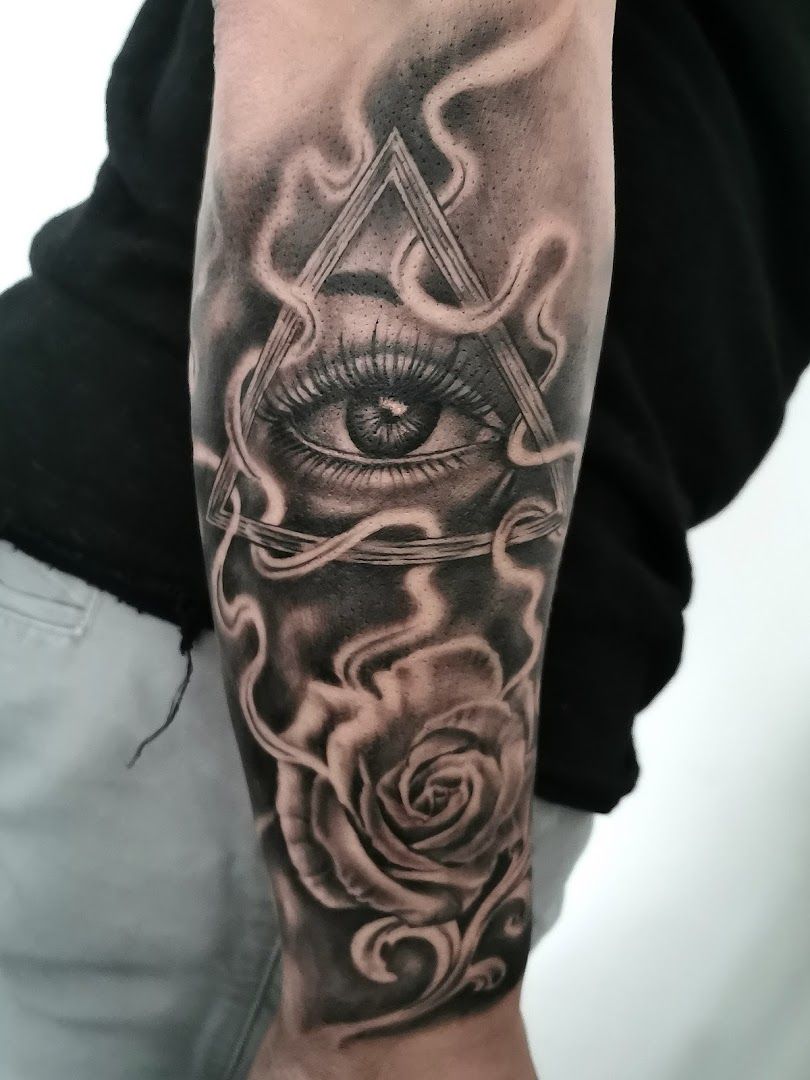 a black and grey cover-up tattoo with a rose and an all seeing eye, zollernalbkreis, germany