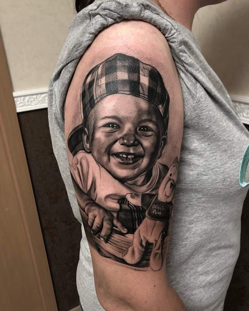 a cover-up tattoo of a baby in a hat, salzlandkreis, germany