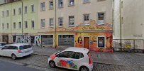 a street with cars parked in front of buildings