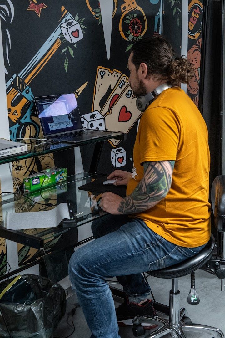 a man sitting at a desk with a laptop