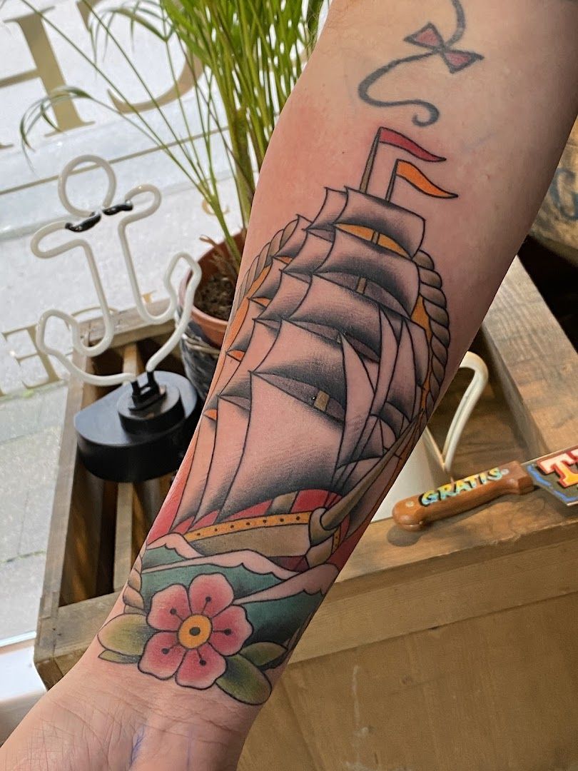 a narben tattoo of a ship with a flower on the arm, duisburg, germany