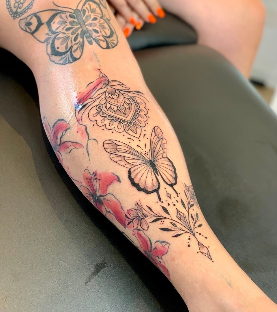 a woman's leg with a cover-up tattoo of butterflies and flowers, rhein-pfalz-kreis, germany