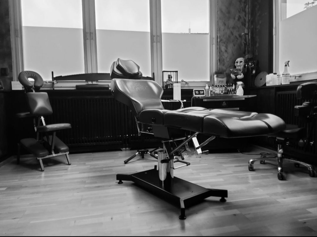 a black and white photo of a barber chair