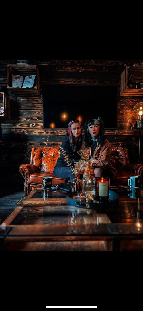 a man and woman sitting on a couch in a dark room