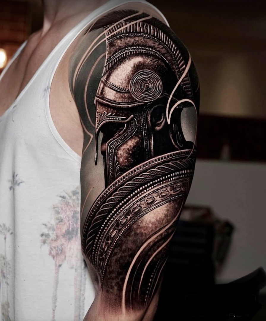 a man with a black and grey cover-up tattoo on his arm, wetteraukreis, germany