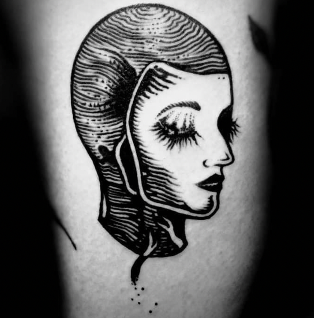 a cover-up tattoo of a woman's face with a black and white ink, berlin, germany