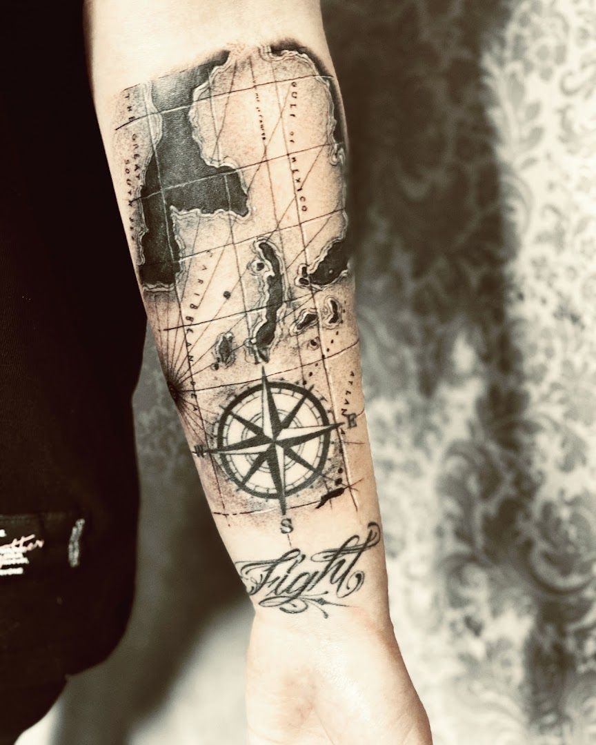 a man with a compass cover-up tattoo on his arm, bochum, germany