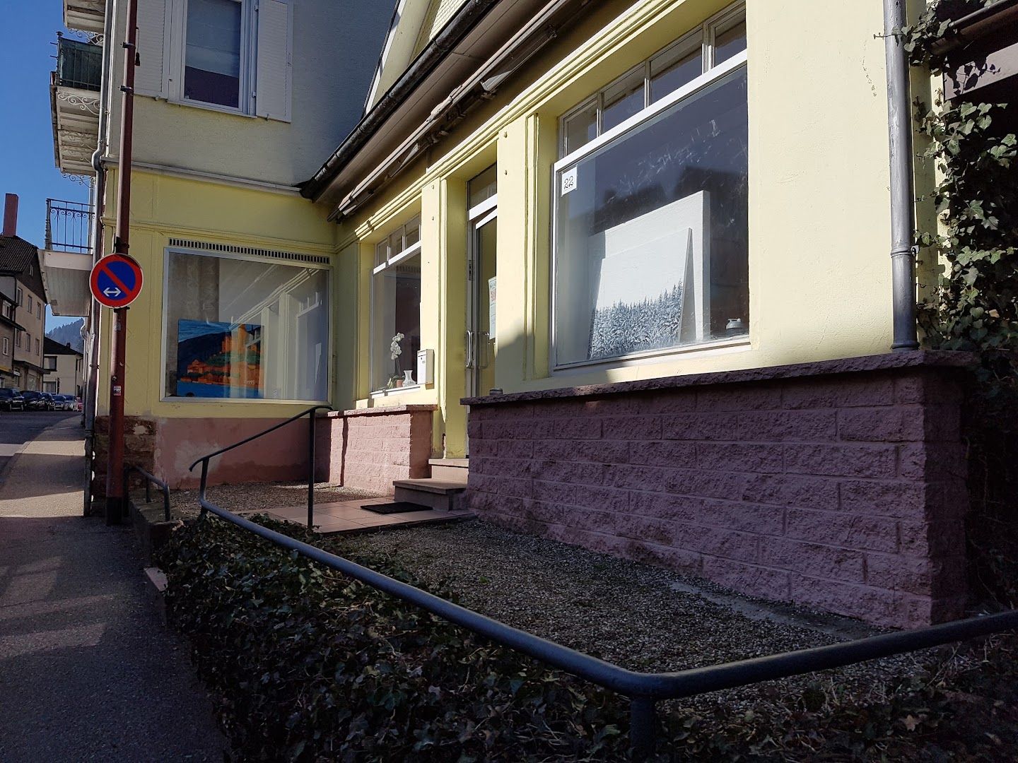 a house with a sign on the side of the street