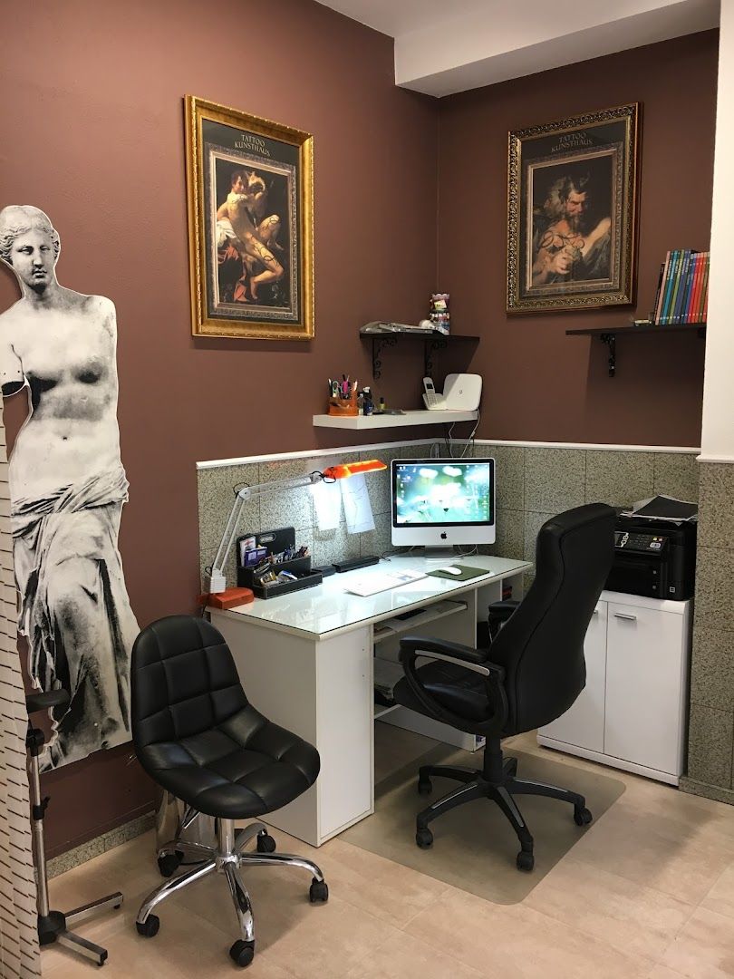 a desk with a computer and a chair