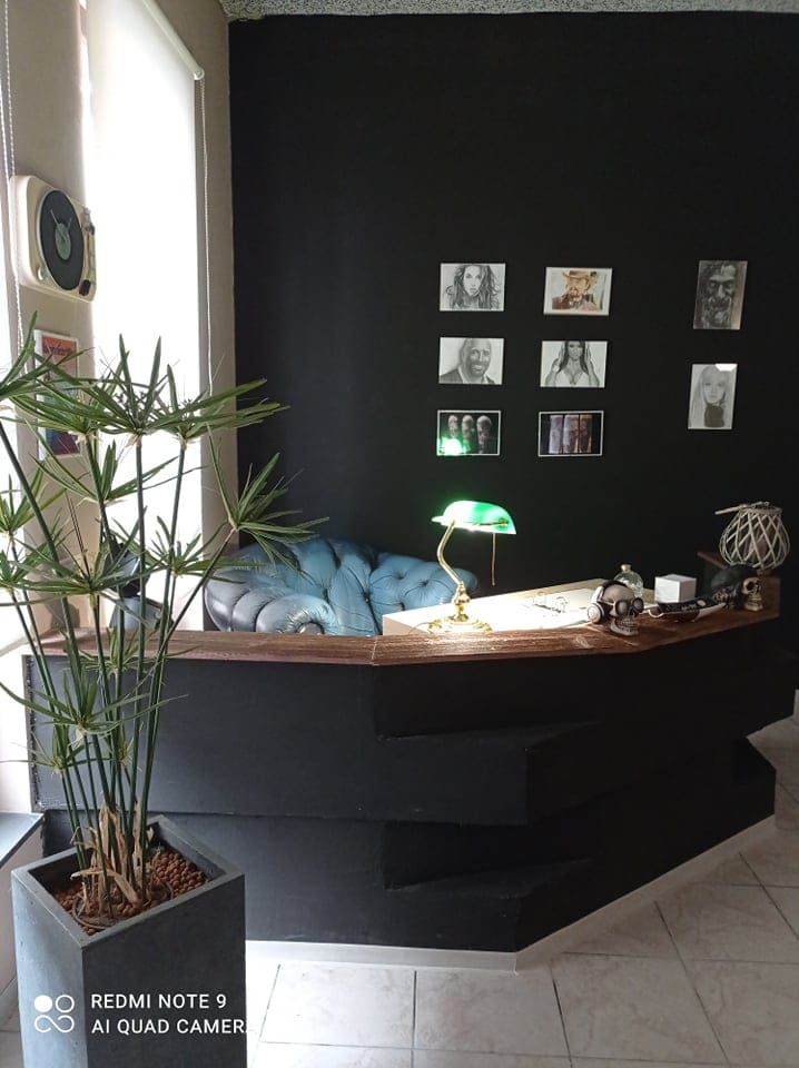 a black wall with a plant in it
