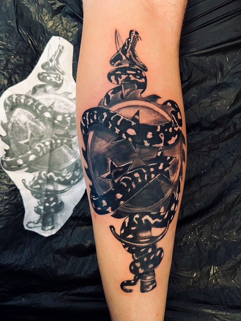 a black and white narben tattoo of a snake with a clock, burgenlandkreis, germany