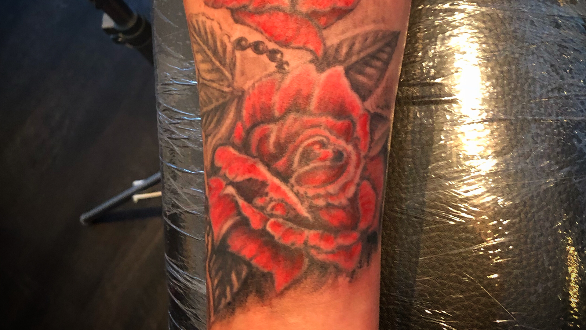 a trashpolka tattoos with red roses on the arm, dillingen, germany