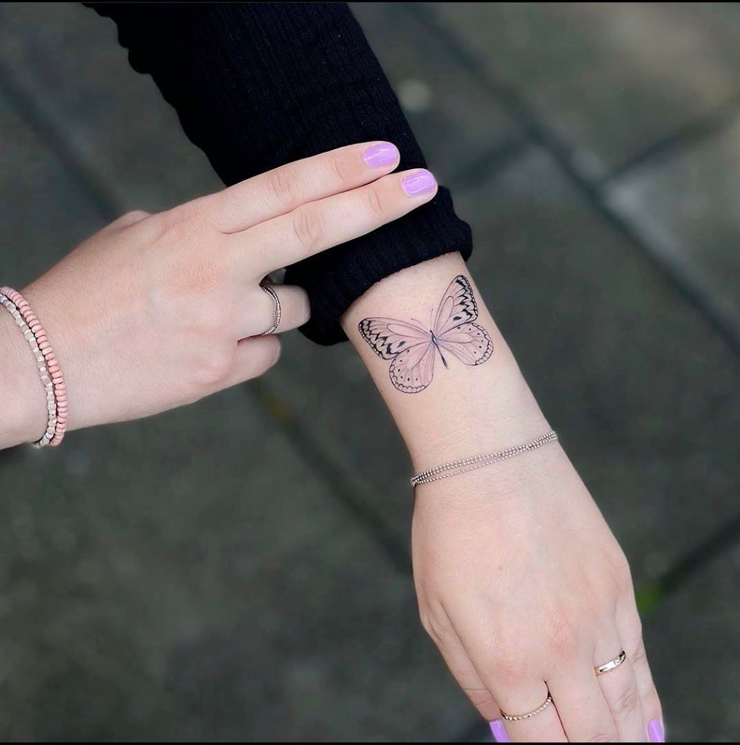 a woman's wrist narben tattoo with a butterfly on it, unstrut-hainich-kreis, germany