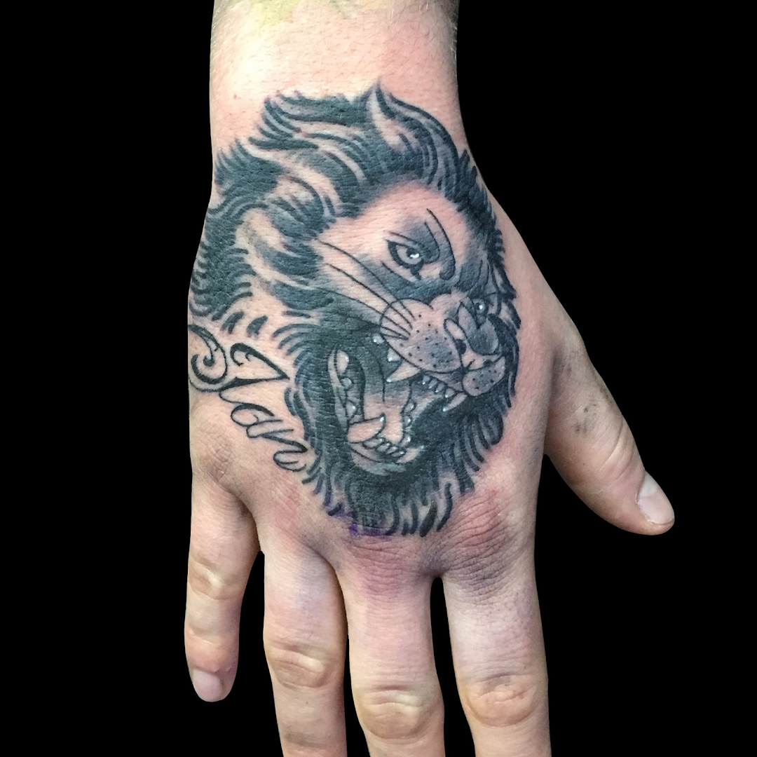 a hand with a narben tattoo of a lion on it, dresden, germany