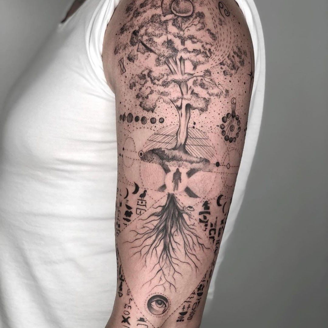 a man with a black and white cover-up tattoo on his arm, berlin, germany