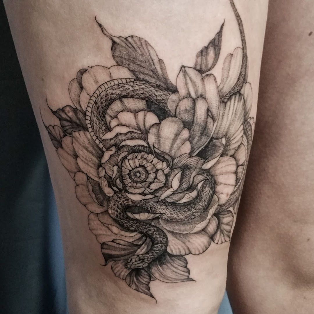 a black and white cover-up tattoo design of a snake and flowers, paderborn, germany