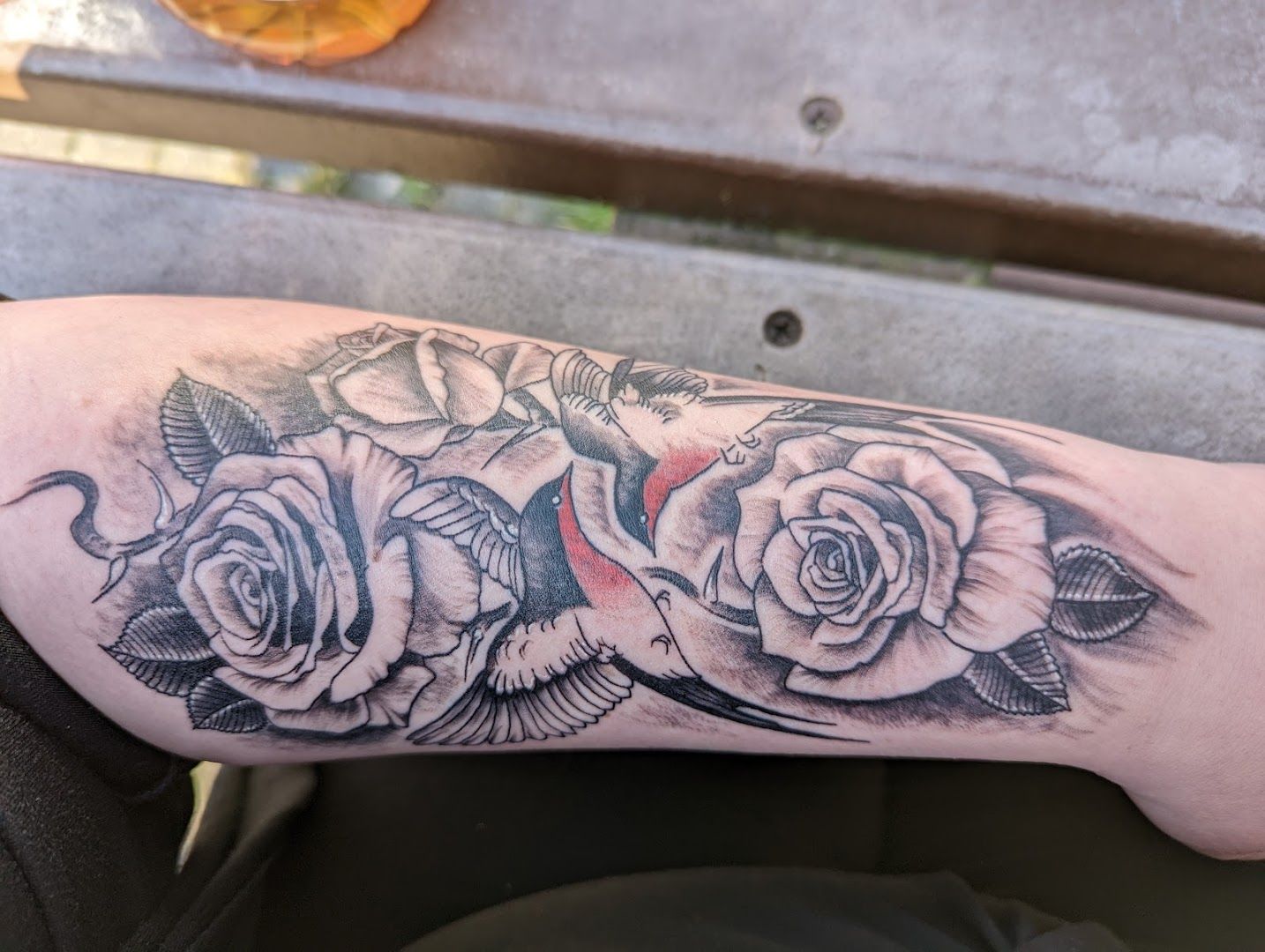 a cover-up tattoo with roses and birds on the arm, altenkirchen, germany