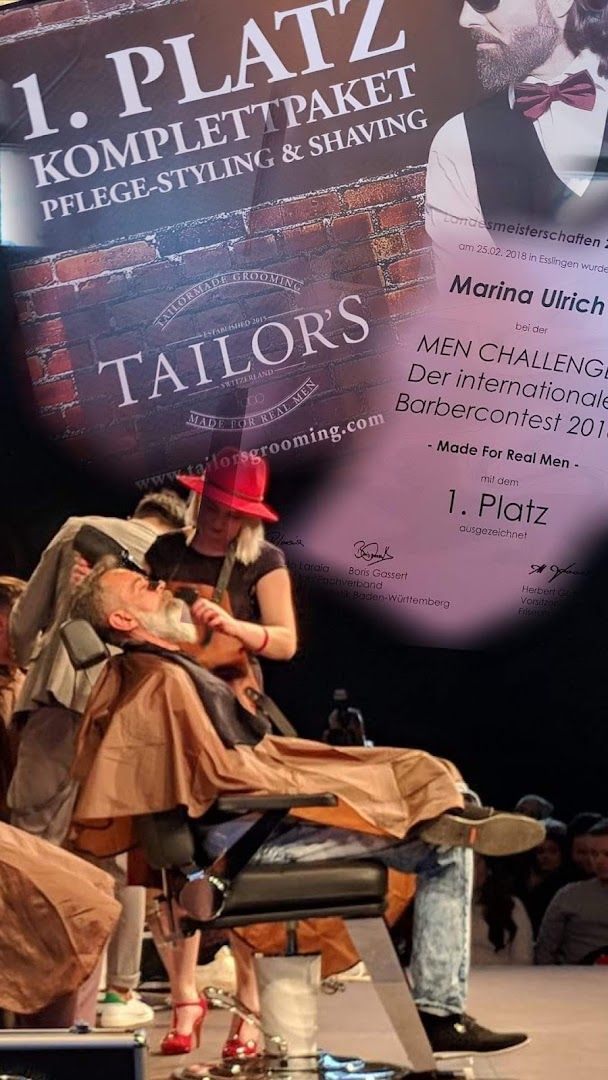 a man sitting on a chair in front of a poster