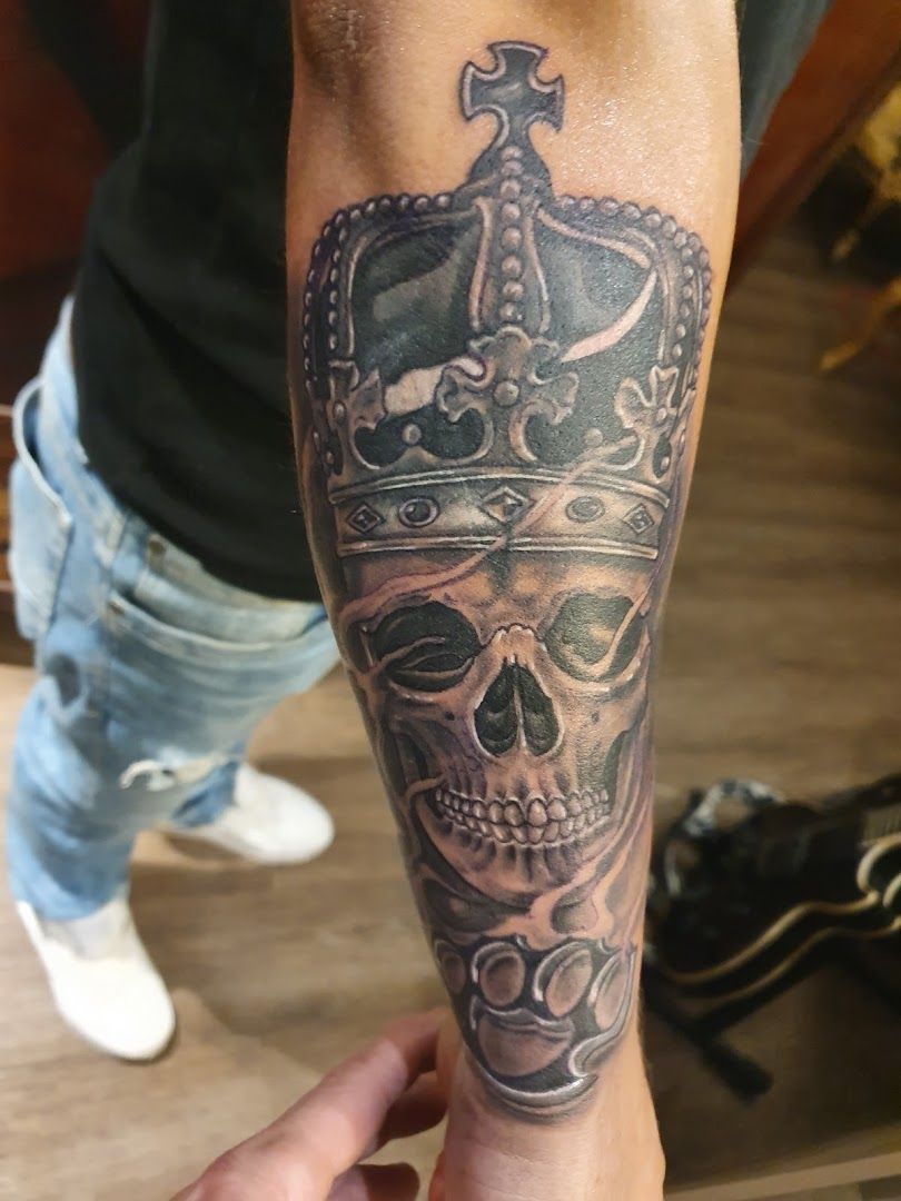 a skull with a crown totenkopf tattoos on the forearm, borken, germany