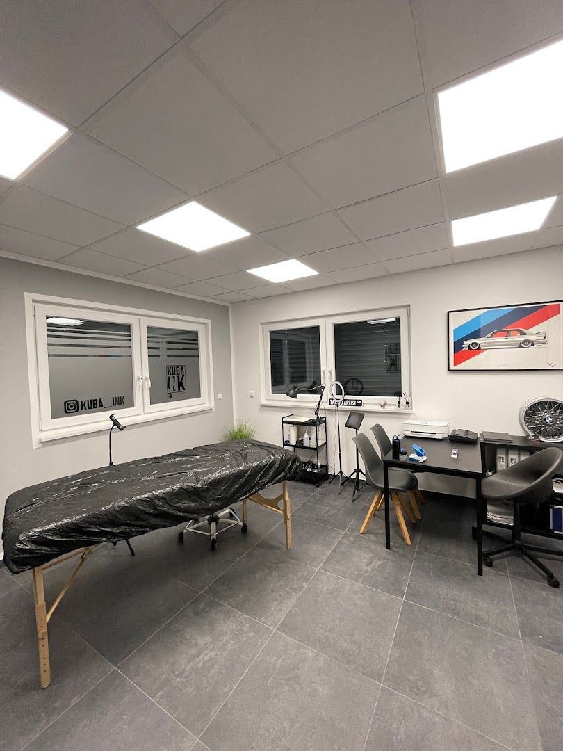 a room with a desk, chair and a television