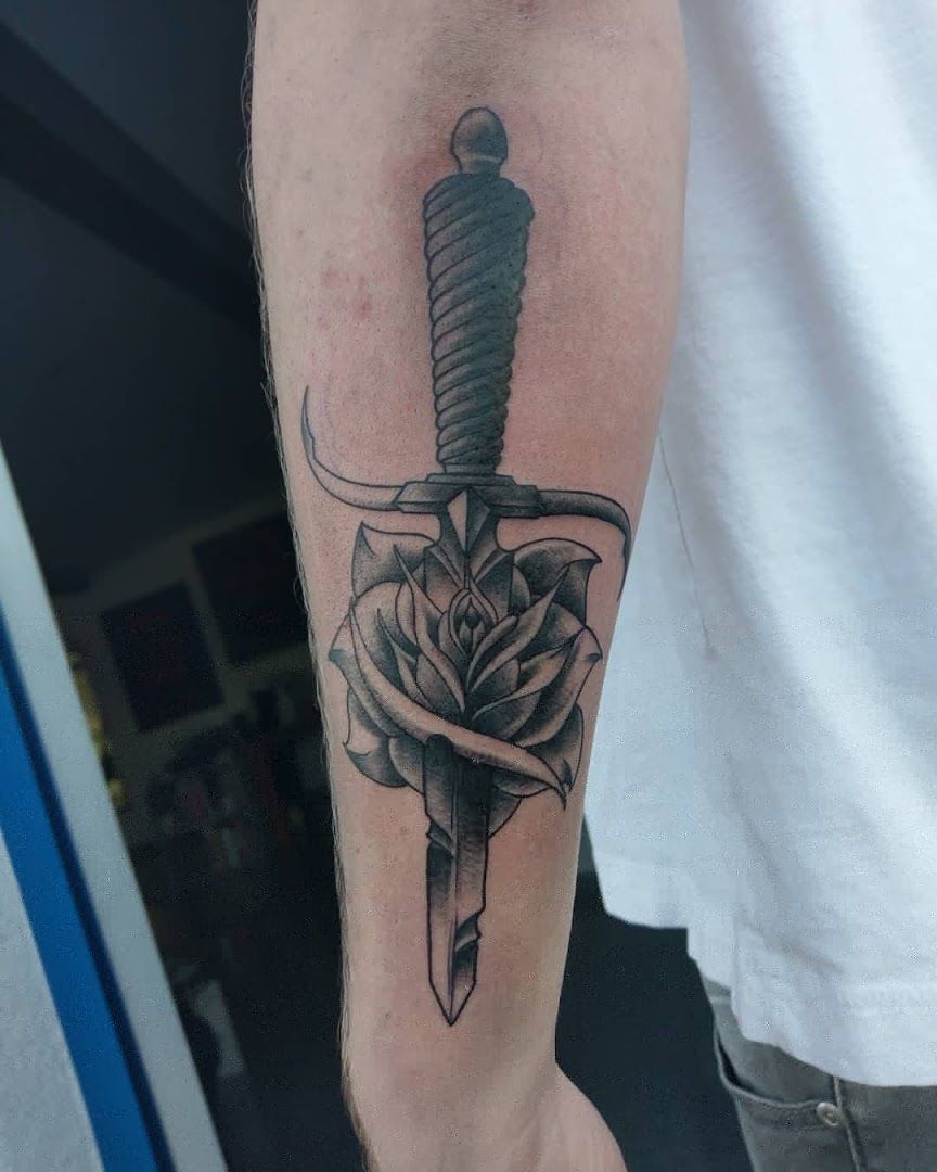 a dagger and rose cover-up tattoo on the forearm, darmstadt-dieburg, germany