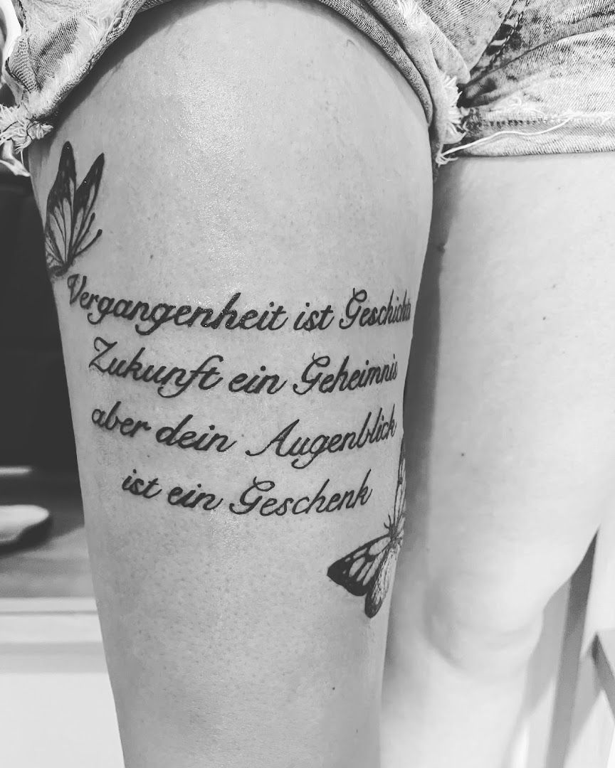 a woman's leg with a quote on it