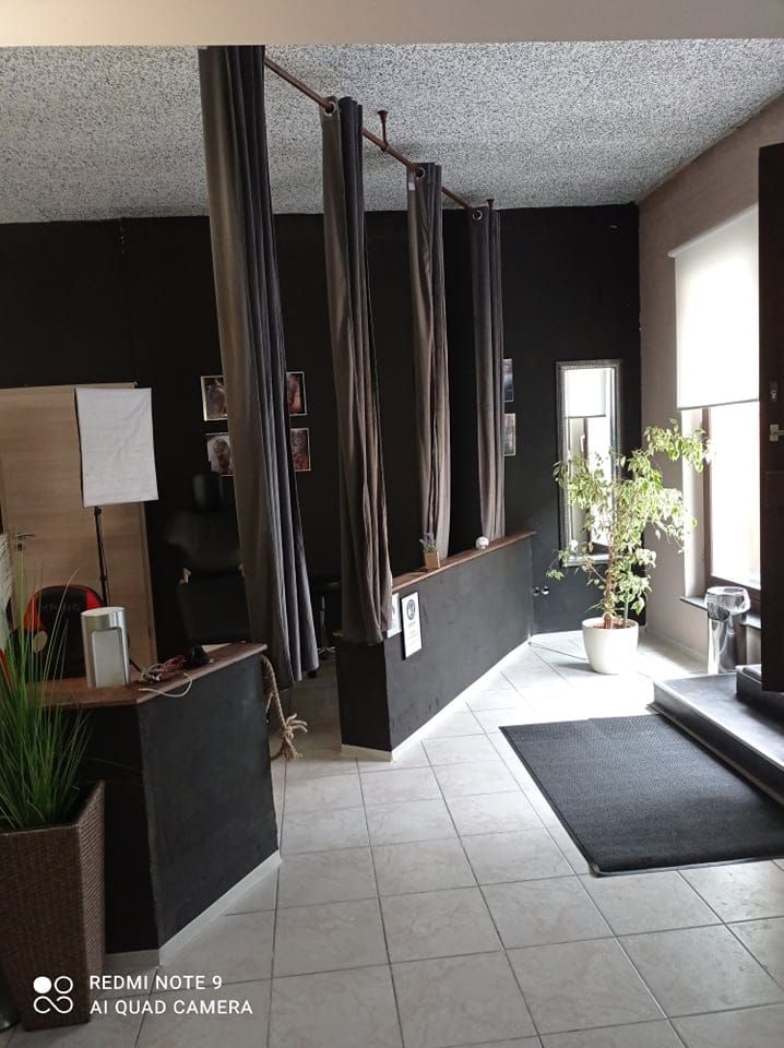 a room with a couch and a black wall