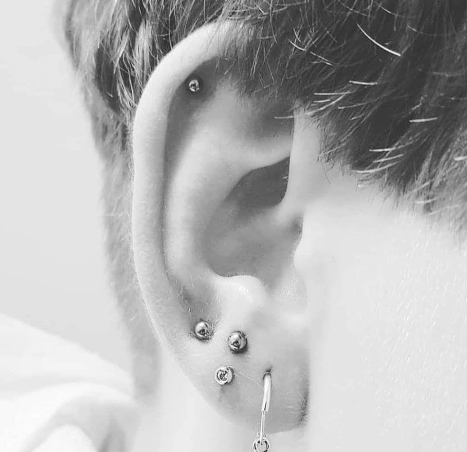 a man wearing a pair of ear piercings