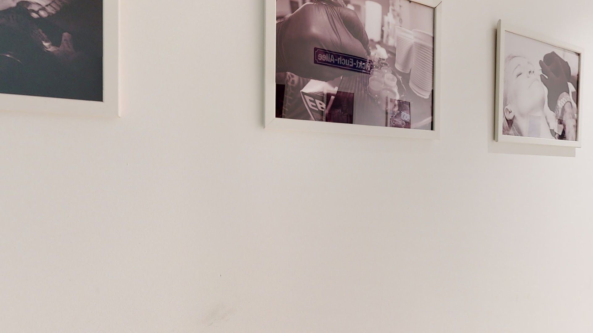 a wall with pictures hanging on it