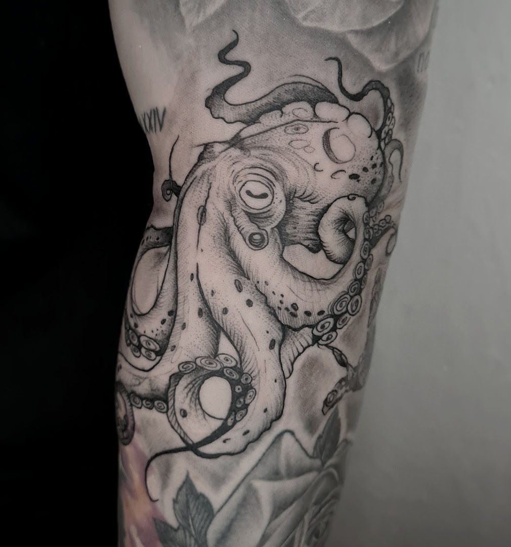 a black and white cover-up tattoo of an octopus with a skull on it, kreisfreie stadt braunschweig, germany
