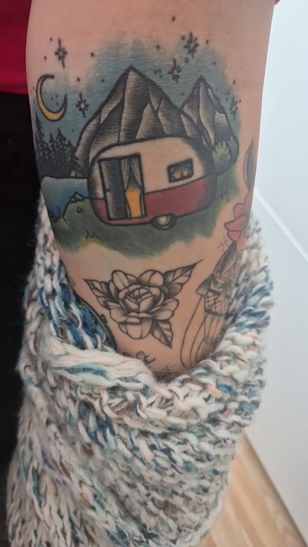 a woman's arm with a japanische tattoos in leipzig of a house and a cat, berlin, germany