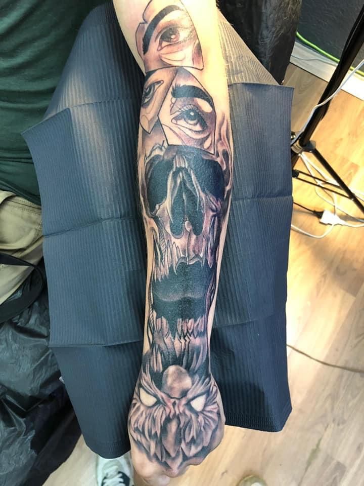 a man with a skull cover-up tattoo on his arm, rheinisch-bergischer kreis, germany