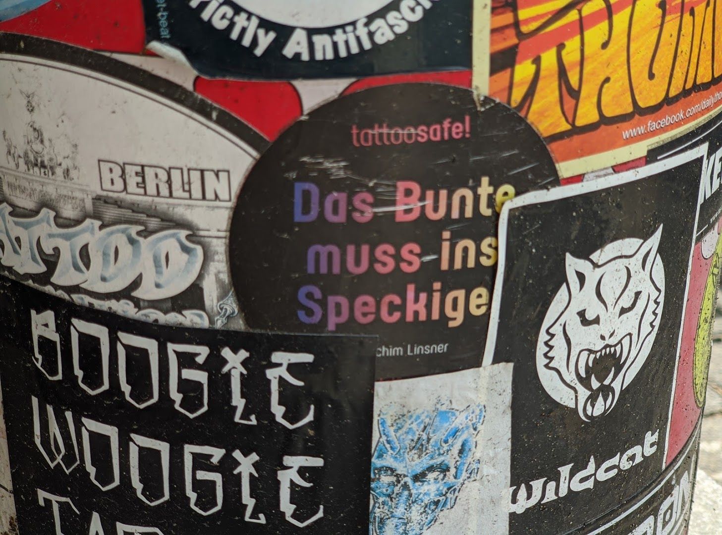 a bunch of stickers on a pole