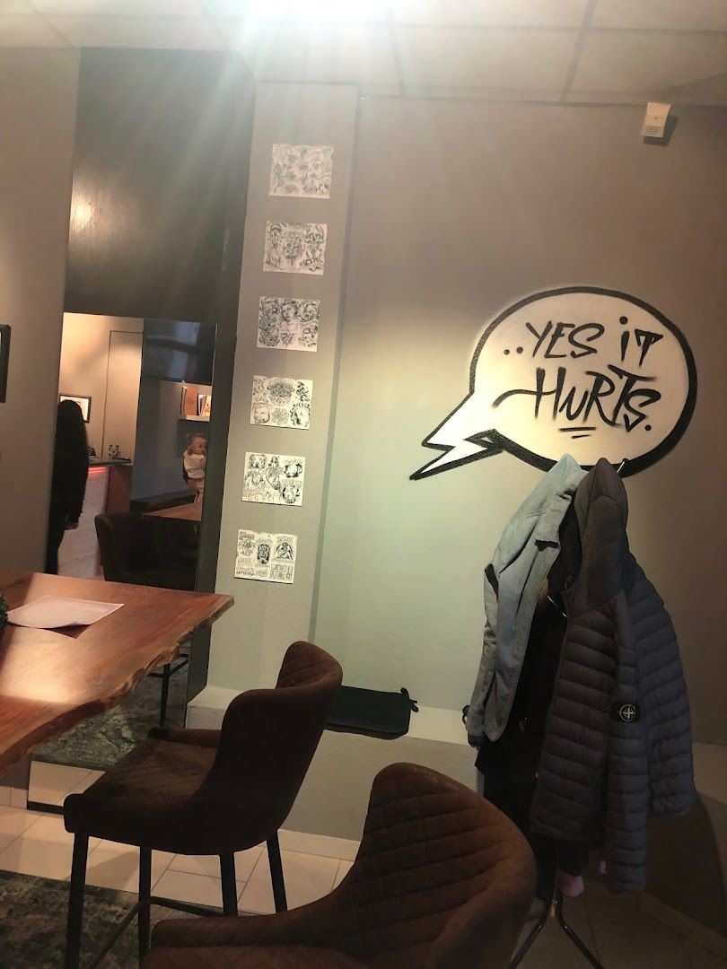 a room with a table and chairs and a wall with graffiti