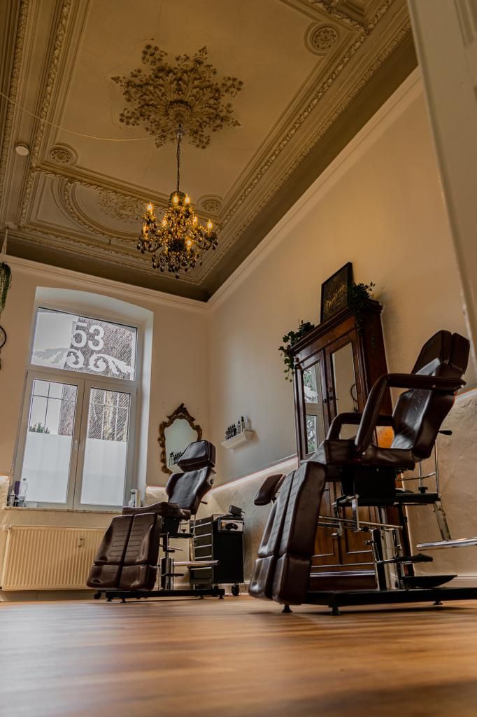 a salon room with a chandel and chairs
