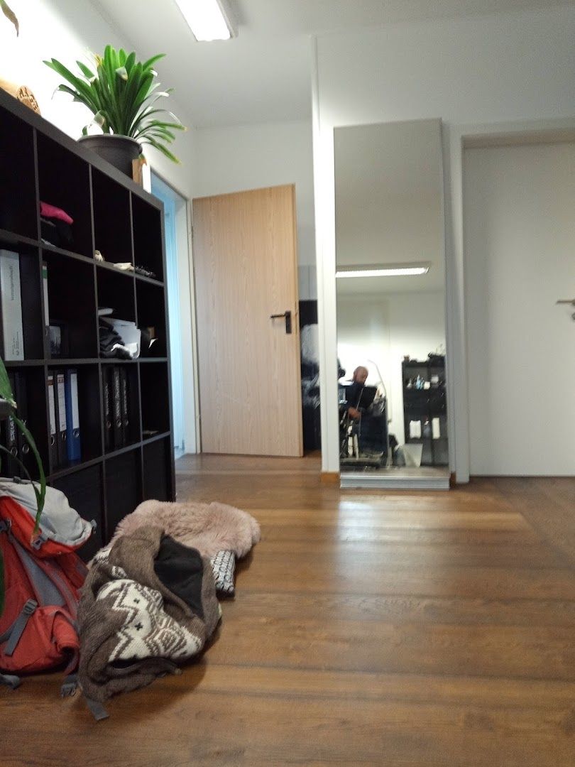 a room with a wooden floor and a bookcase