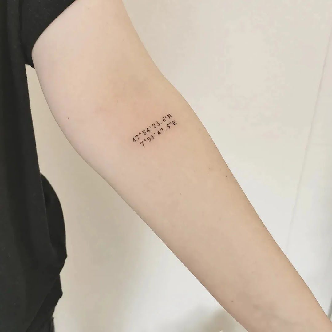 a woman's arm with a small narben tattoo saying, breisgau-hochschwarzwald, germany