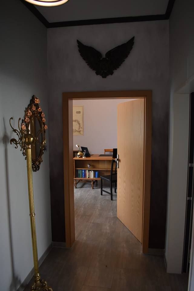 a hallway with a desk and a lamp