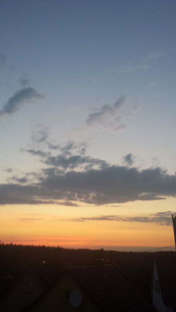 a sunset view from the roof of a house