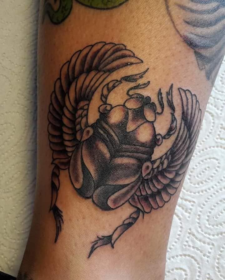 a narben tattoo of a rhino with wings on the leg, heidekreis, germany