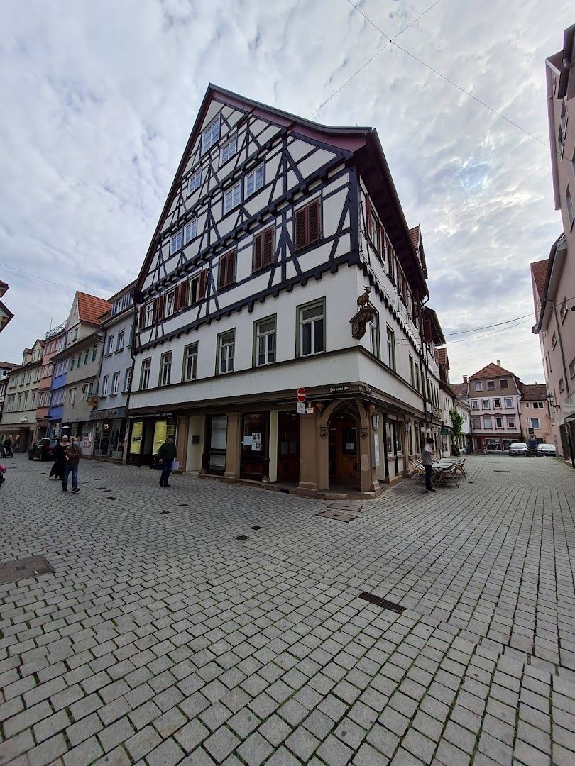 a street with a building and a person walking by