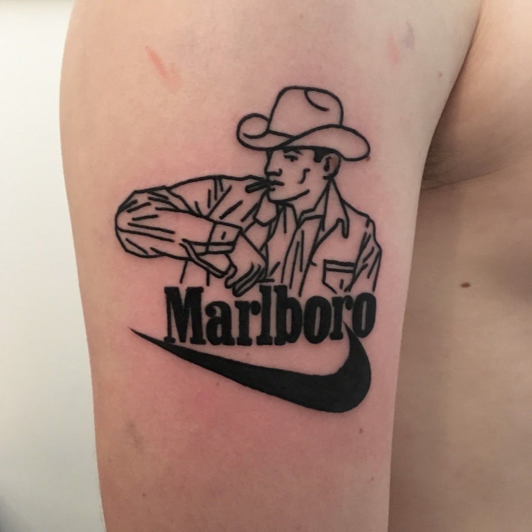 a cover-up tattoo of a cowboy with the word'golia ', frankfurt, germany