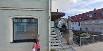 a woman walking down a street next to a building