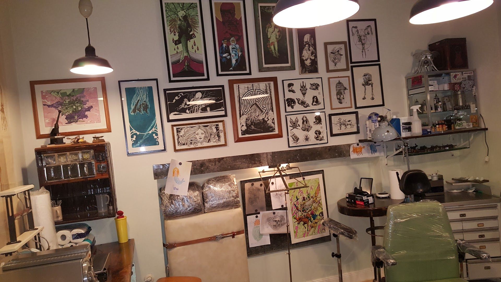 a room with a desk, chair, and pictures on the wall