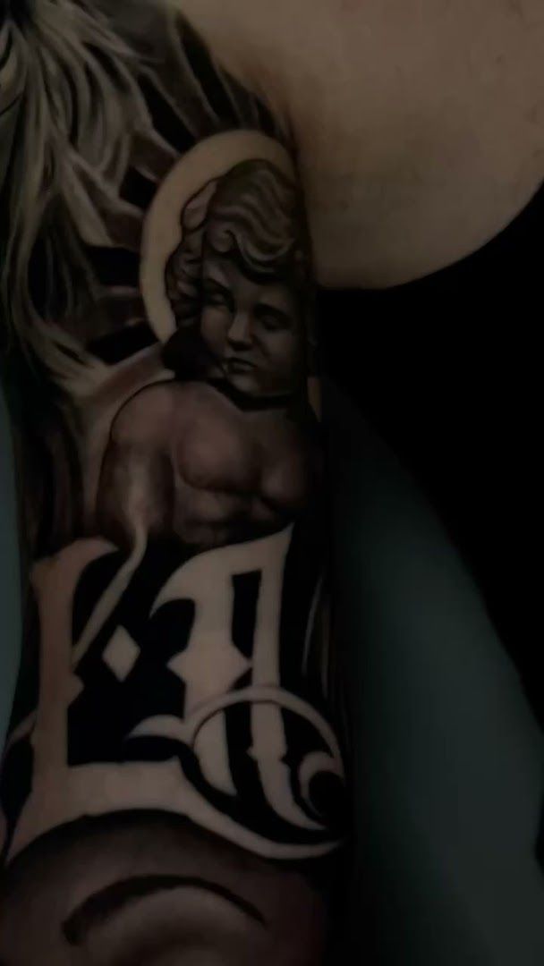 a man with a cover-up tattoo on his arm, bodenseekreis, germany