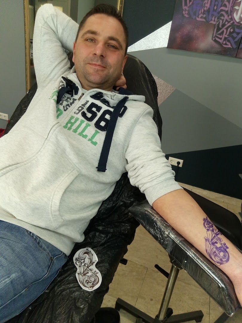 a man sitting in a chair with his arm up